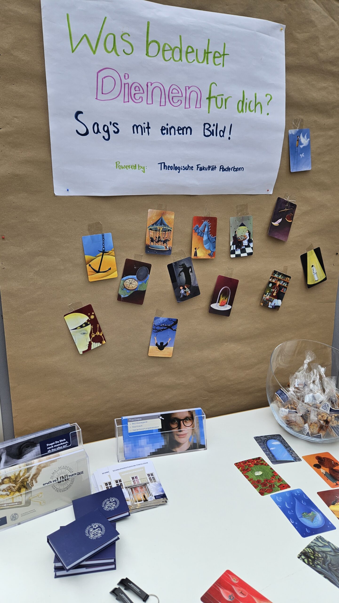 Ein Info-Stand mit einer Bildersammlung zum Thema "Was bedeutet Dienen für dich?"